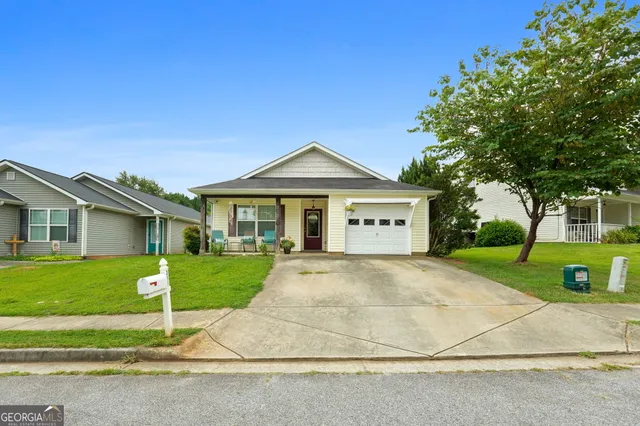 a front view of a house with a yard and garage