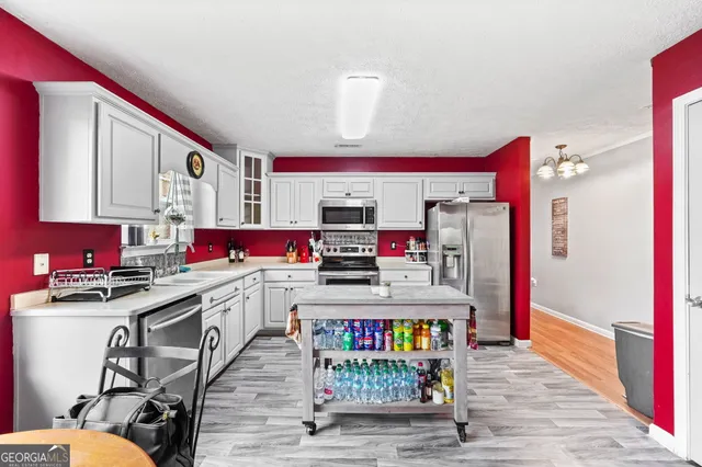 a kitchen with stainless steel appliances granite countertop a stove and cabinets