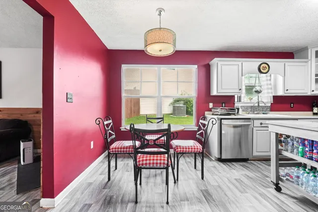 a dining room with furniture and wooden floor