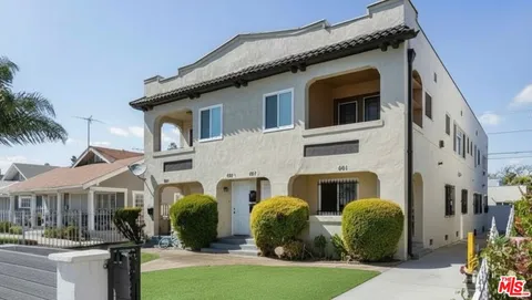 a front view of a residential houses with yard