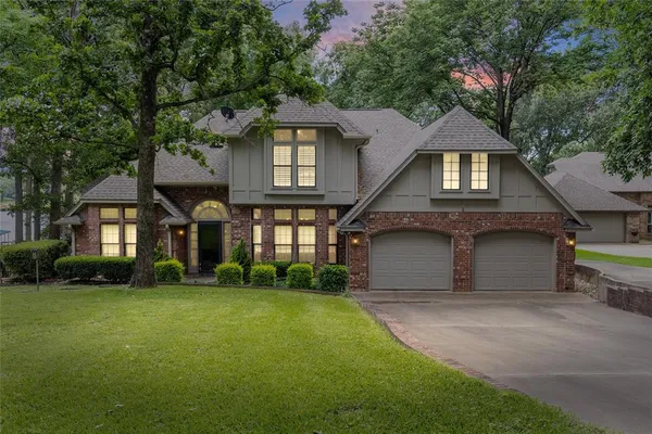 a front view of a house with a yard and garage
