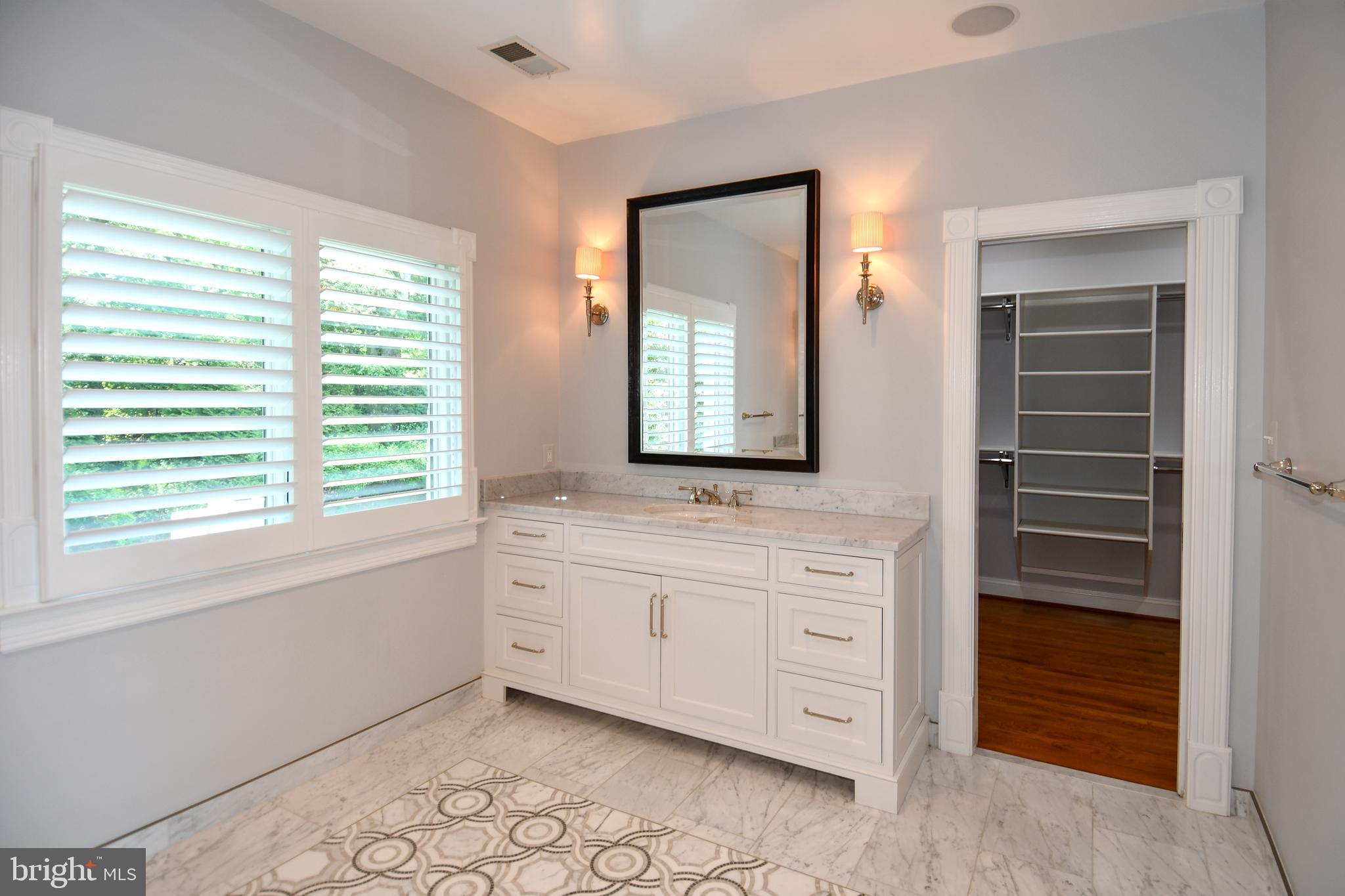 7808 Southdown Road Alexandria, VA 22308 - Photo 66 of 99 a bathroom with a granite countertop sink and a mirror