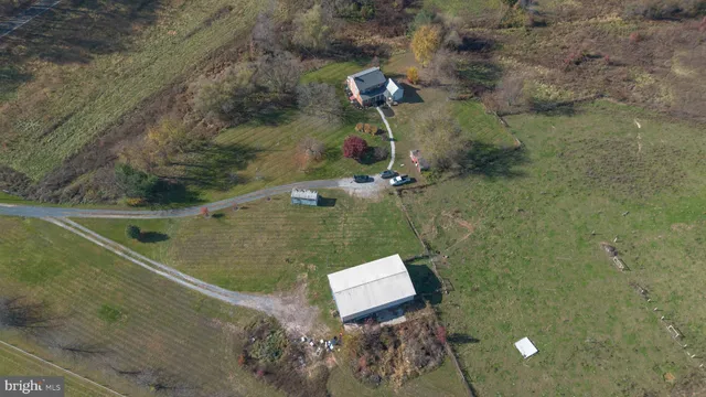 an aerial view of a house with a yard