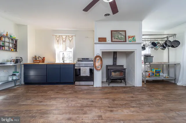 a view of kitchen with refrigerator cabinets and ceiling fan