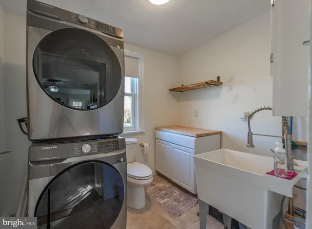 a spacious bedroom with a bed and a flat screen tv