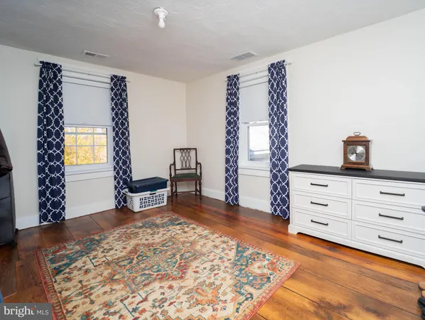 a large bed sitting in a bedroom next to a window