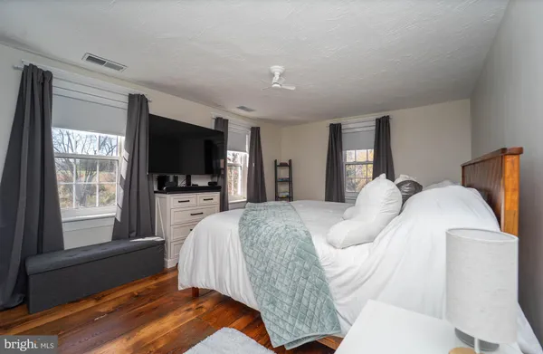 a view of a bedroom with workspace and a window