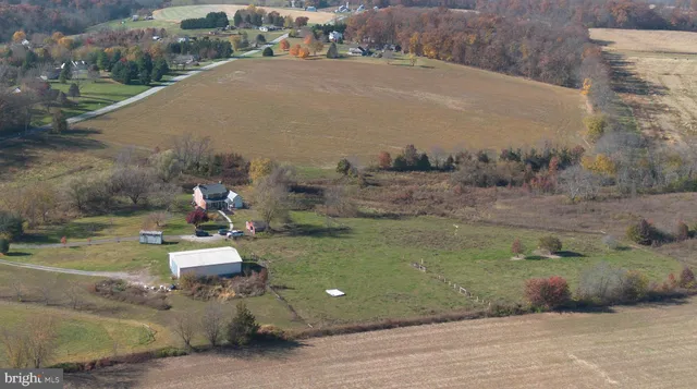an aerial view of a house with outdoor space
