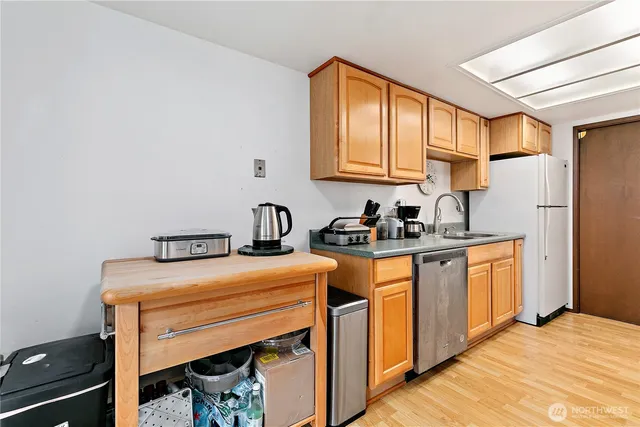 a kitchen with stainless steel appliances a sink stove and cabinets