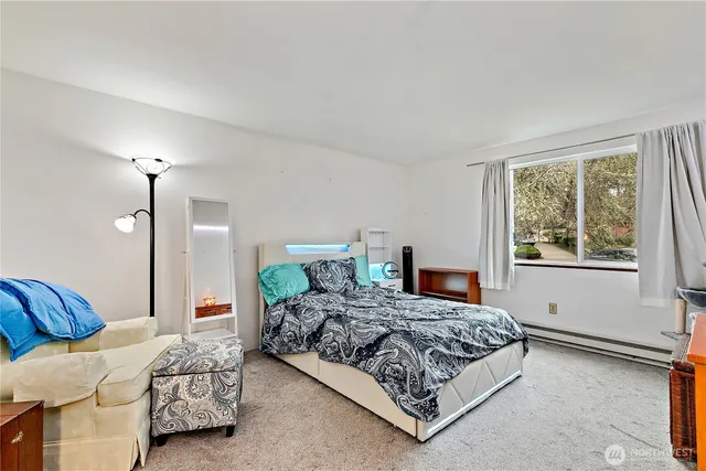 a bedroom with a bed flowerpot and window