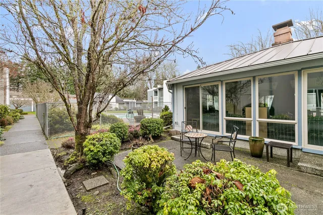 a view of a house with sitting area and garden