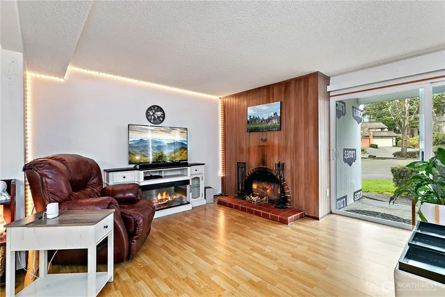 a living room with furniture tv and a fireplace