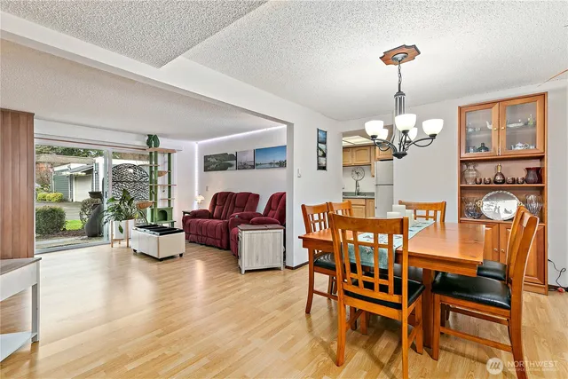 a view of a dining room with furniture wooden floor and chandelier
