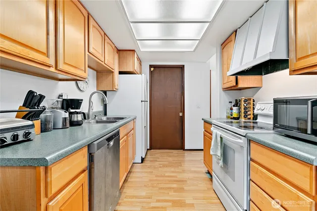a kitchen with stainless steel appliances granite countertop a sink and cabinets
