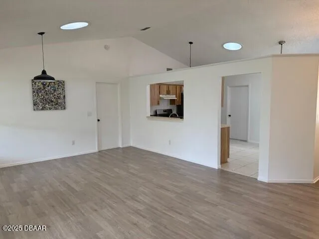 a view of a livingroom with wooden floor and a ceiling fan
