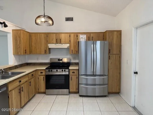 a kitchen with stainless steel appliances granite countertop a stove a refrigerator and a stove
