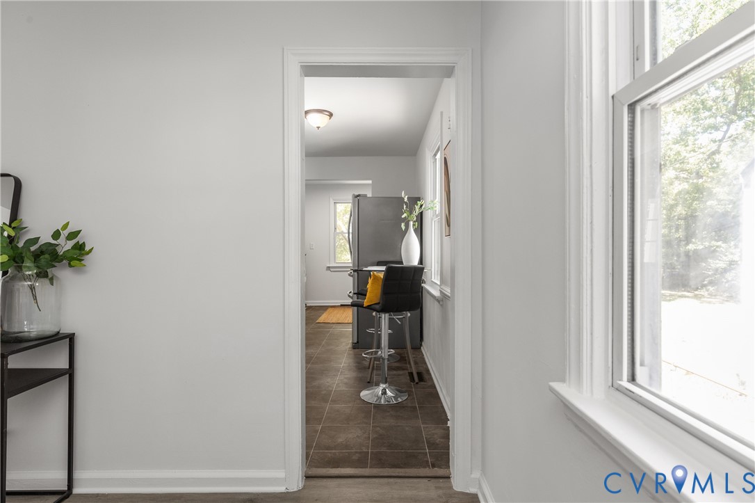 3406 Meadowbridge Road Richmond, VA 23222 - Photo 10 of 12 Hallway with light gray walls, white trim, and a d