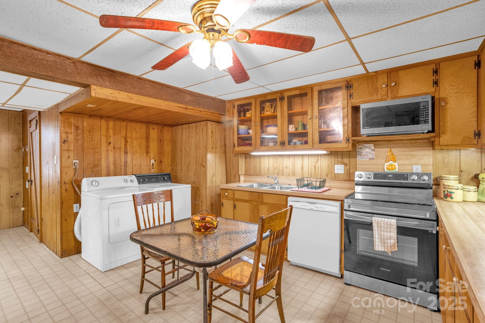 723 Hill Everhart Road Lexington, NC 27295 - Photo 27 of 48 a kitchen with a stove a sink a dining table and chairs