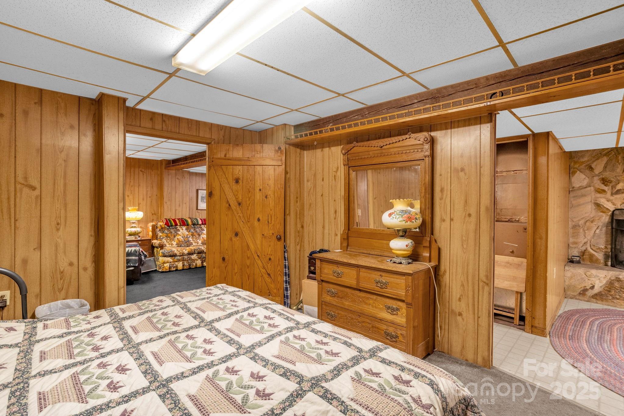 723 Hill Everhart Road Lexington, NC 27295 - Photo 32 of 48 a bedroom with a bed and dresser with mirror