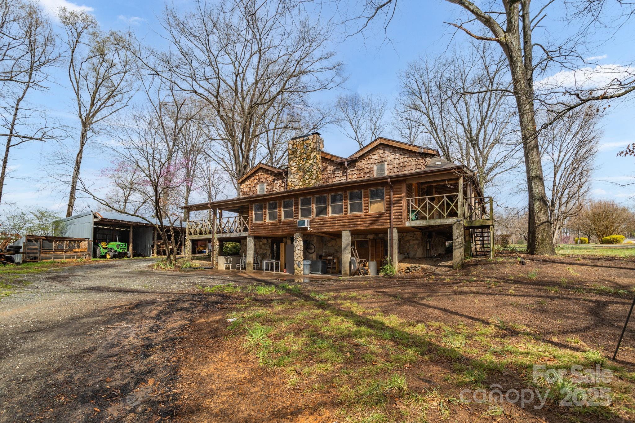 723 Hill Everhart Road Lexington, NC 27295 - Photo 42 of 48 a front view of a building with large trees
