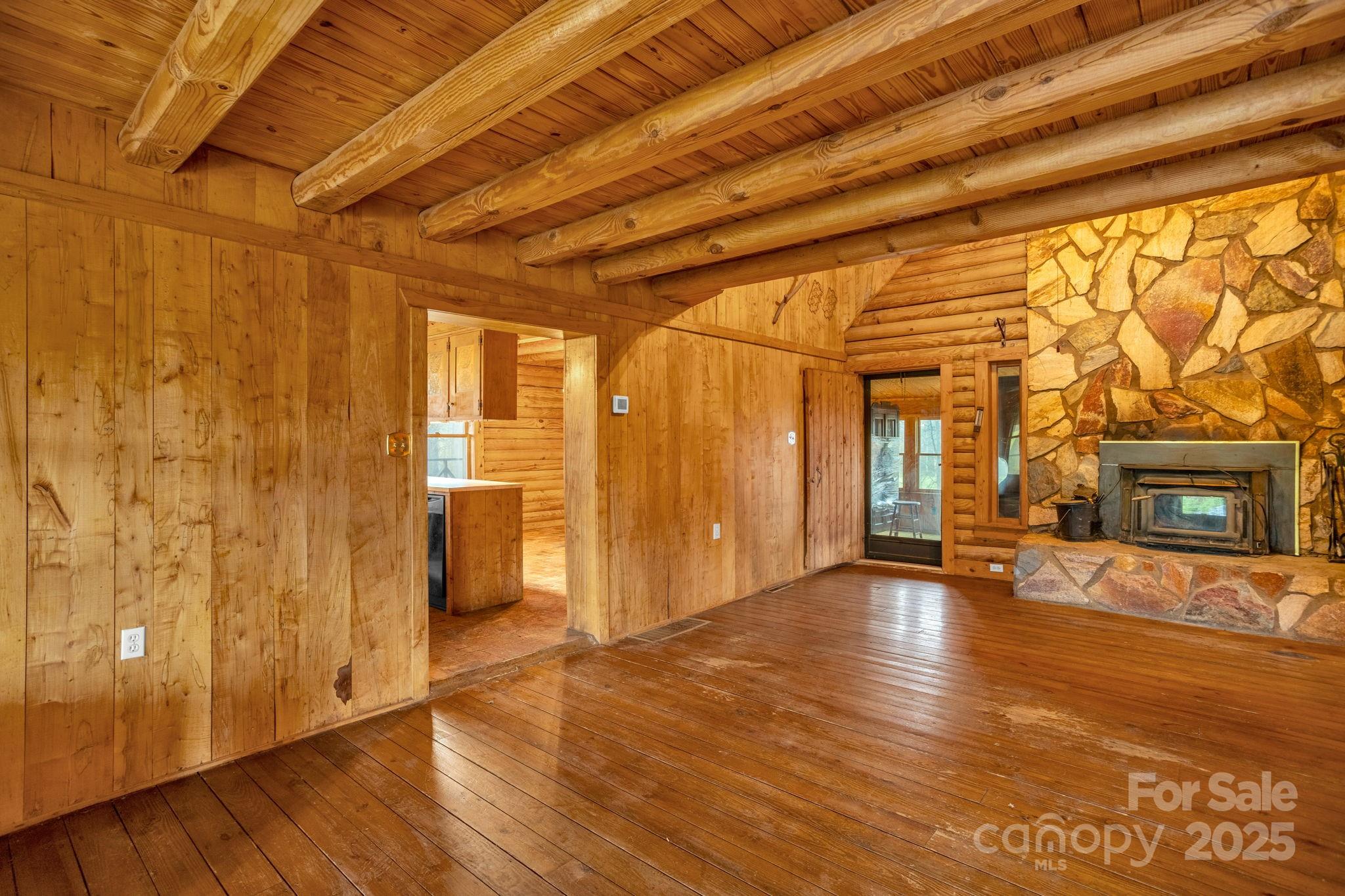 723 Hill Everhart Road Lexington, NC 27295 - Photo 6 of 48 a view of an empty room with wooden floor and a window