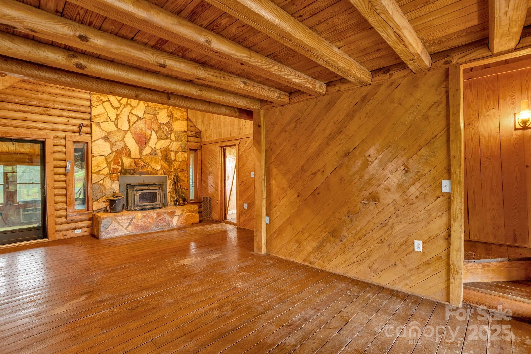 723 Hill Everhart Road Lexington, NC 27295 - Photo 7 of 48 a view of an empty room with wooden floor and a window