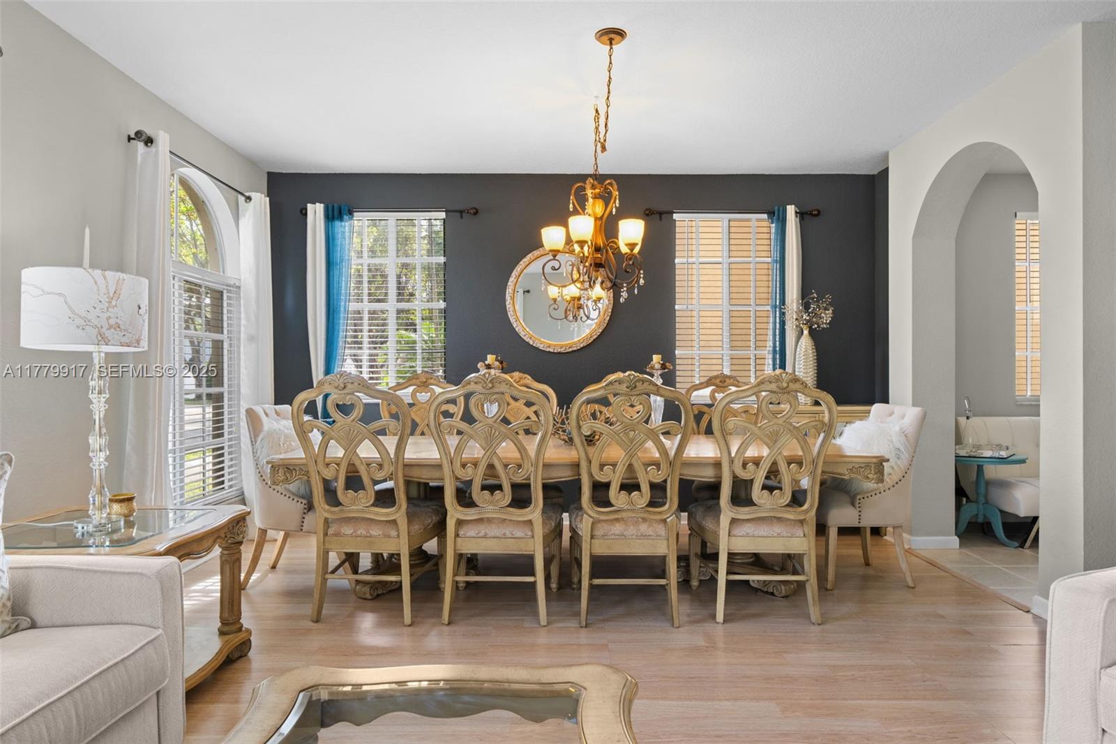 13990 Southwest 274th Terrace Homestead, FL 33032 - Photo 14 of 60 a dining room with furniture a large window and a chandelier