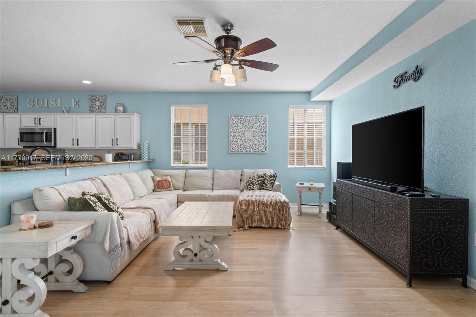 13990 Southwest 274th Terrace Homestead, FL 33032 - Photo 18 of 60 a living room with furniture and a flat screen tv