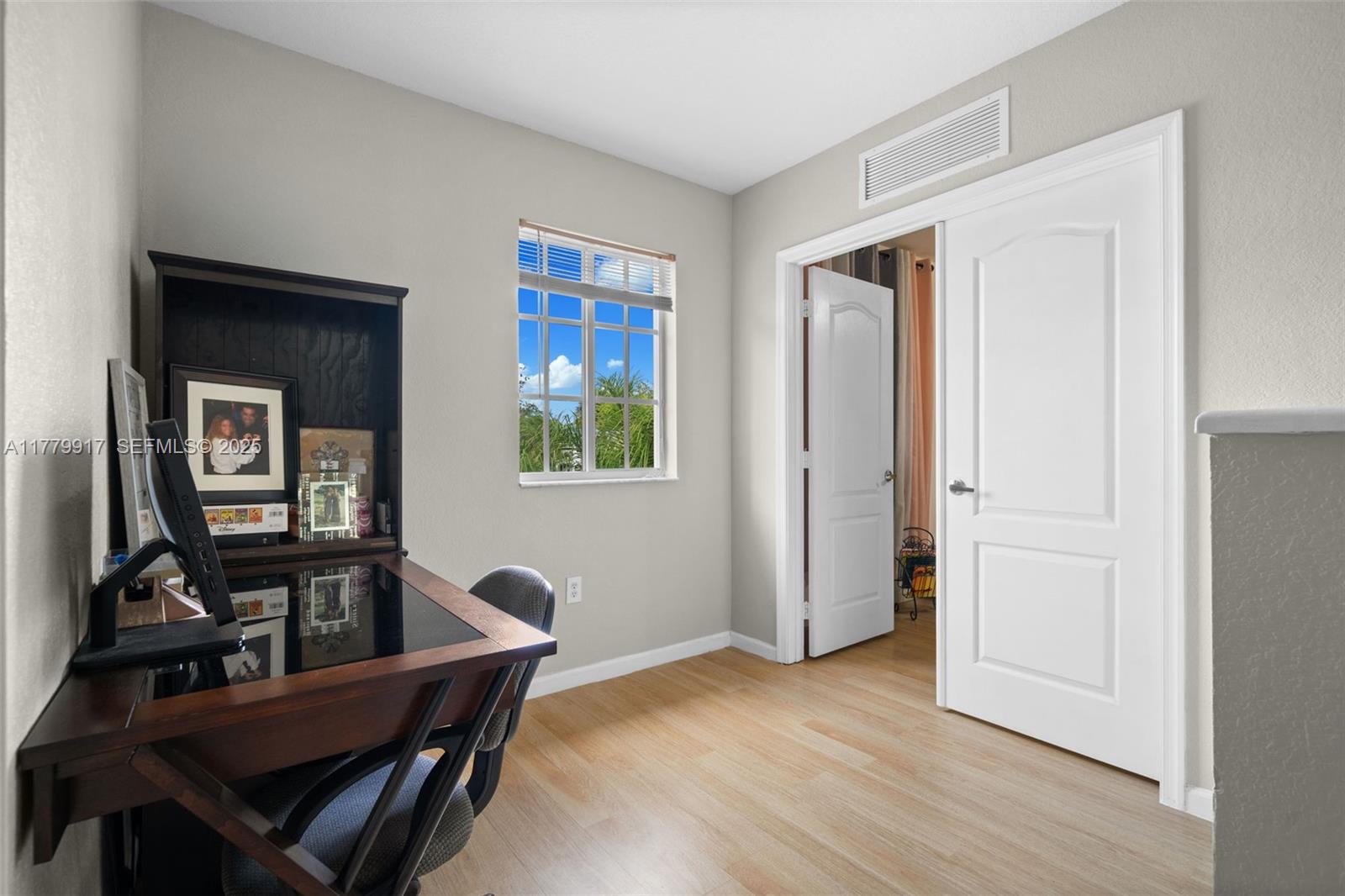 13990 Southwest 274th Terrace Homestead, FL 33032 - Photo 27 of 60 a view of a workspace with furniture and a window