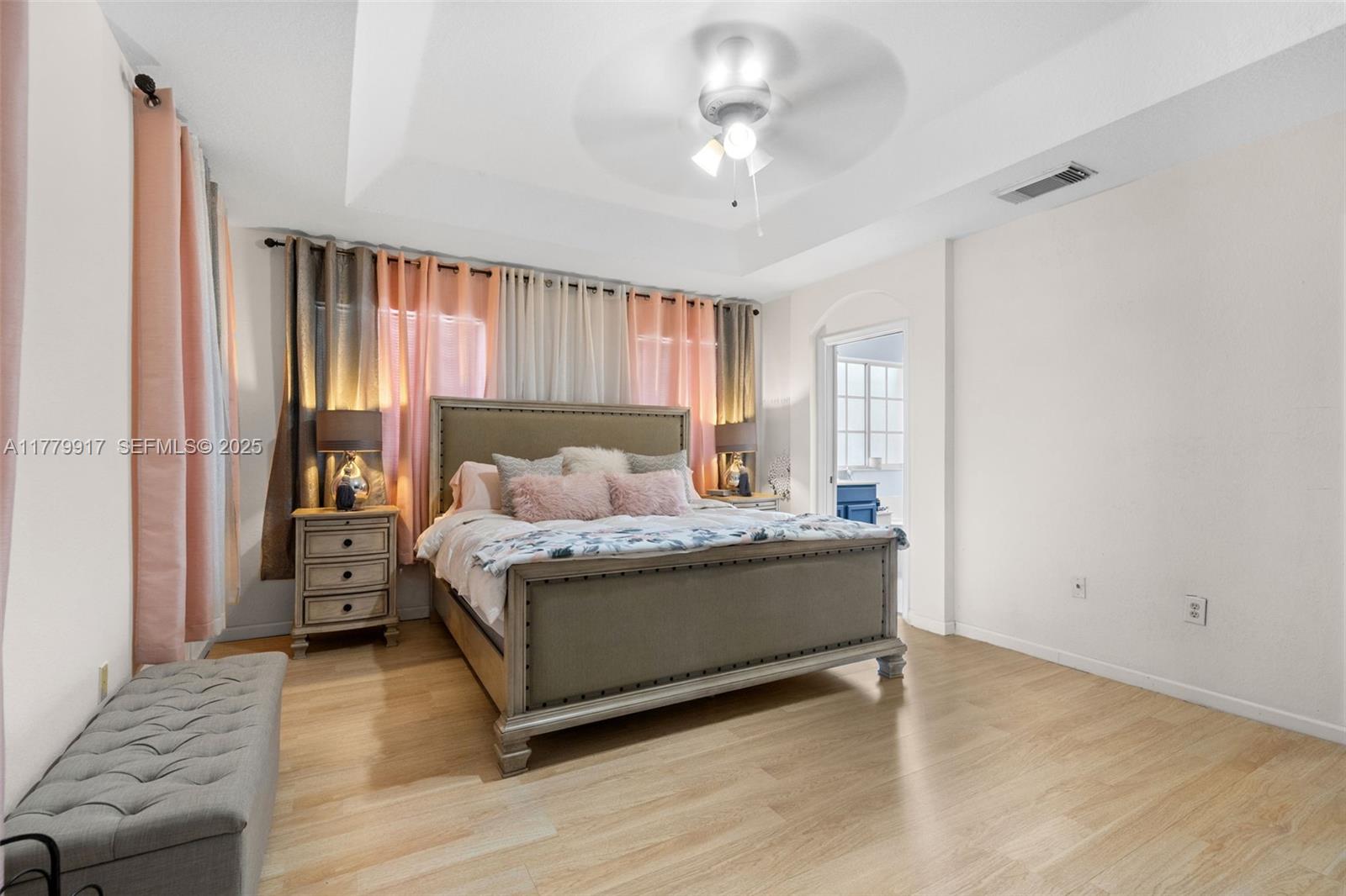 13990 Southwest 274th Terrace Homestead, FL 33032 - Photo 29 of 60 a bedroom with a bed and a chandelier