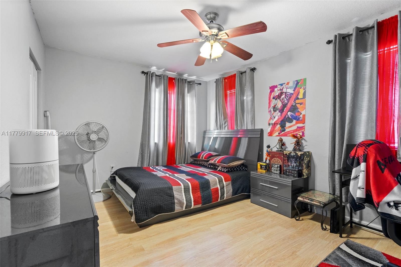 13990 Southwest 274th Terrace Homestead, FL 33032 - Photo 38 of 60 a bed room with a bed and a chandelier