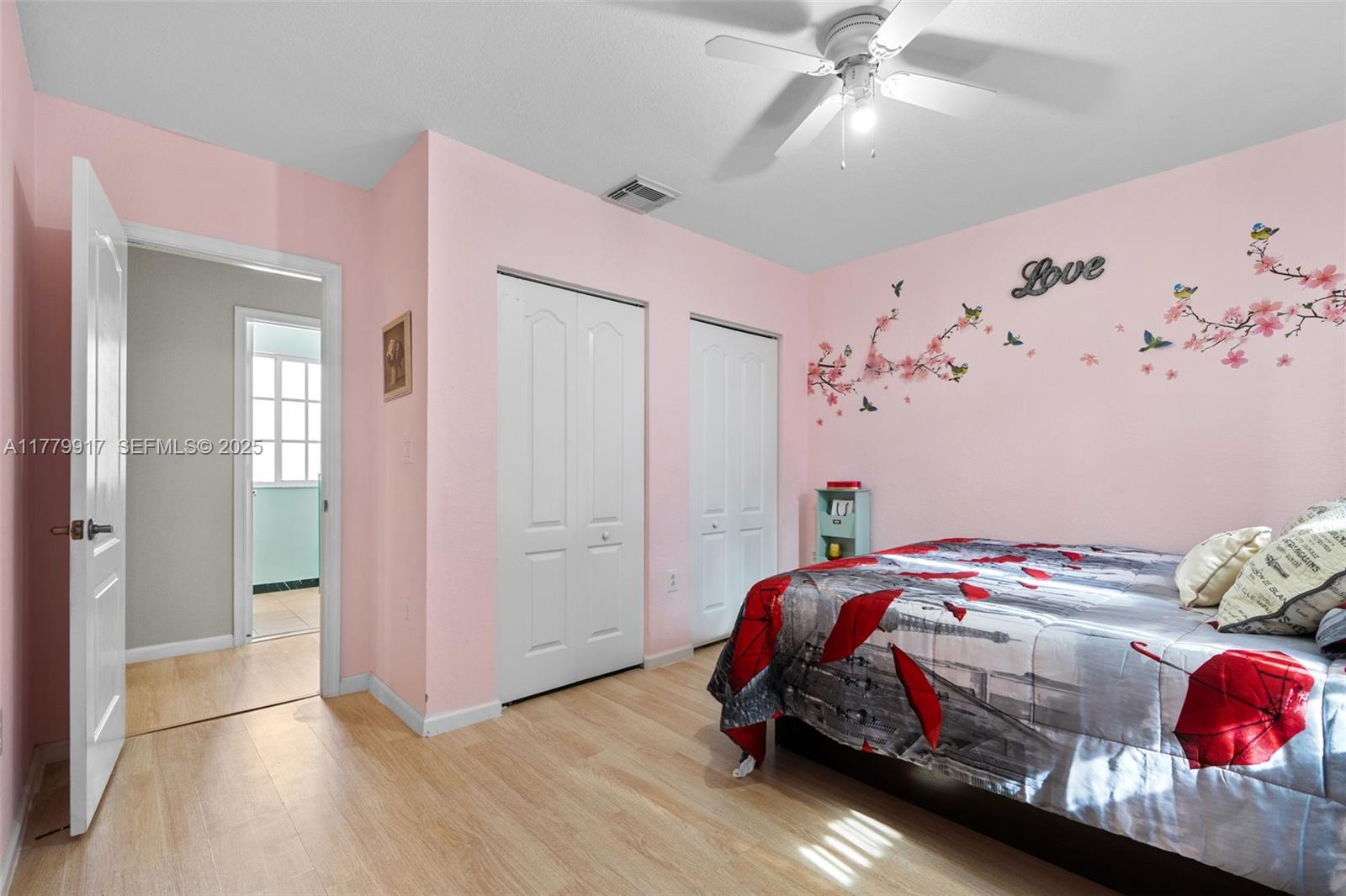 13990 Southwest 274th Terrace Homestead, FL 33032 - Photo 41 of 60 a bedroom with a bed and a chandelier