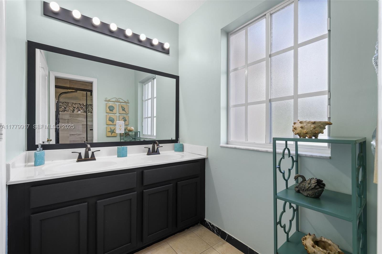 13990 Southwest 274th Terrace Homestead, FL 33032 - Photo 42 of 60 a bathroom with a double vanity sink and a mirror