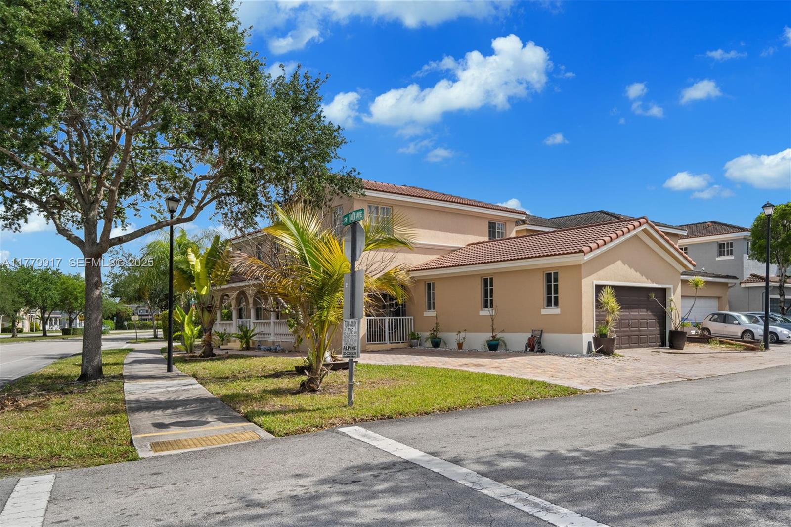 13990 Southwest 274th Terrace Homestead, FL 33032 - Photo 5 of 60 a view of a white house with a swimming pool and a lawn chairs with plants