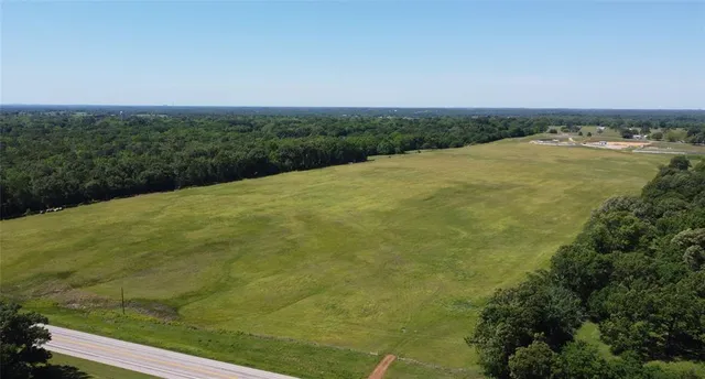 a view of a field with an ocean