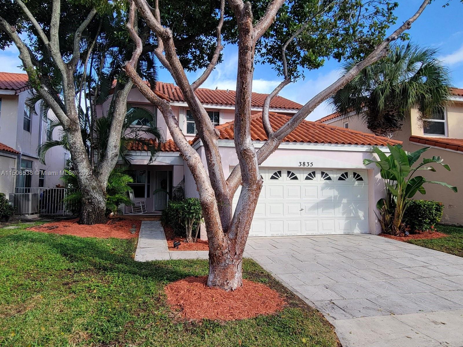3835 Lombardy Street Hollywood, FL 33021 - Photo 4 of 20 a view of a yard with plants and a large tree