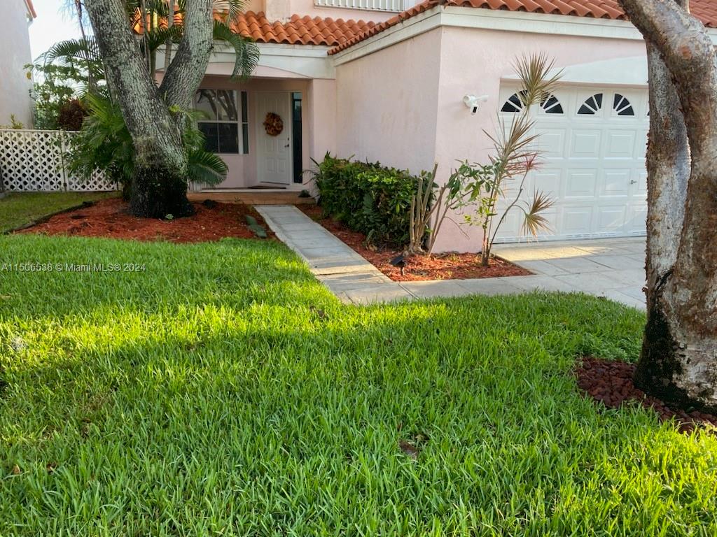 3835 Lombardy Street Hollywood, FL 33021 - Photo 5 of 20 a front view of a house with garden