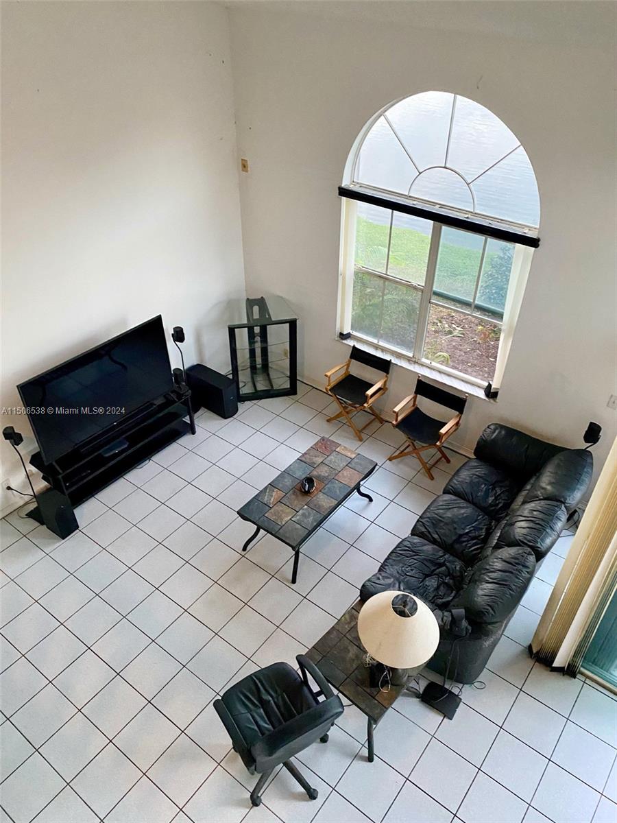 3835 Lombardy Street Hollywood, FL 33021 - Photo 8 of 20 a living room with furniture and a floor to ceiling window