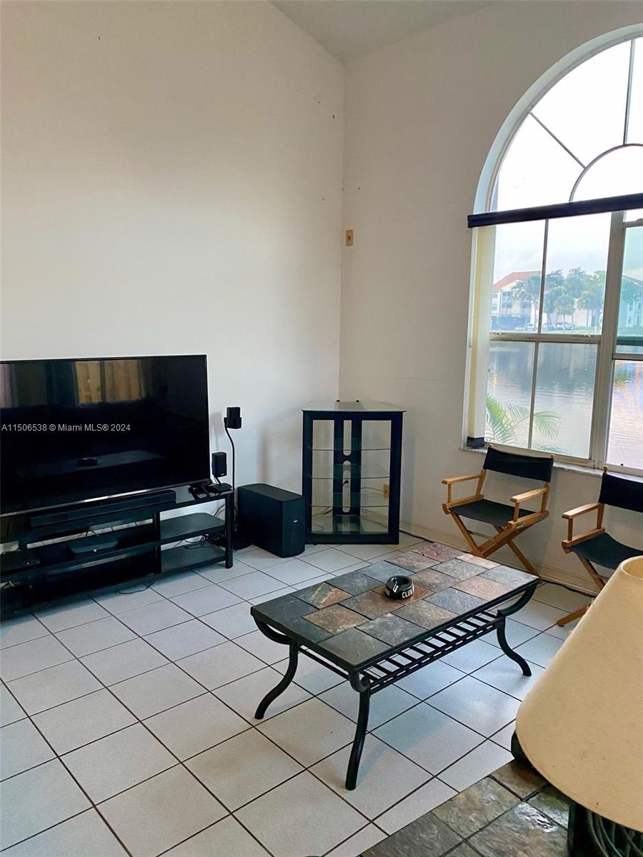 3835 Lombardy Street Hollywood, FL 33021 - Photo 9 of 20 a living room with furniture and a flat screen tv