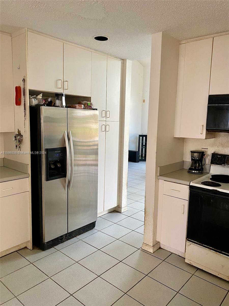 3835 Lombardy Street Hollywood, FL 33021 - Photo 10 of 20 a kitchen with a refrigerator and a stove
