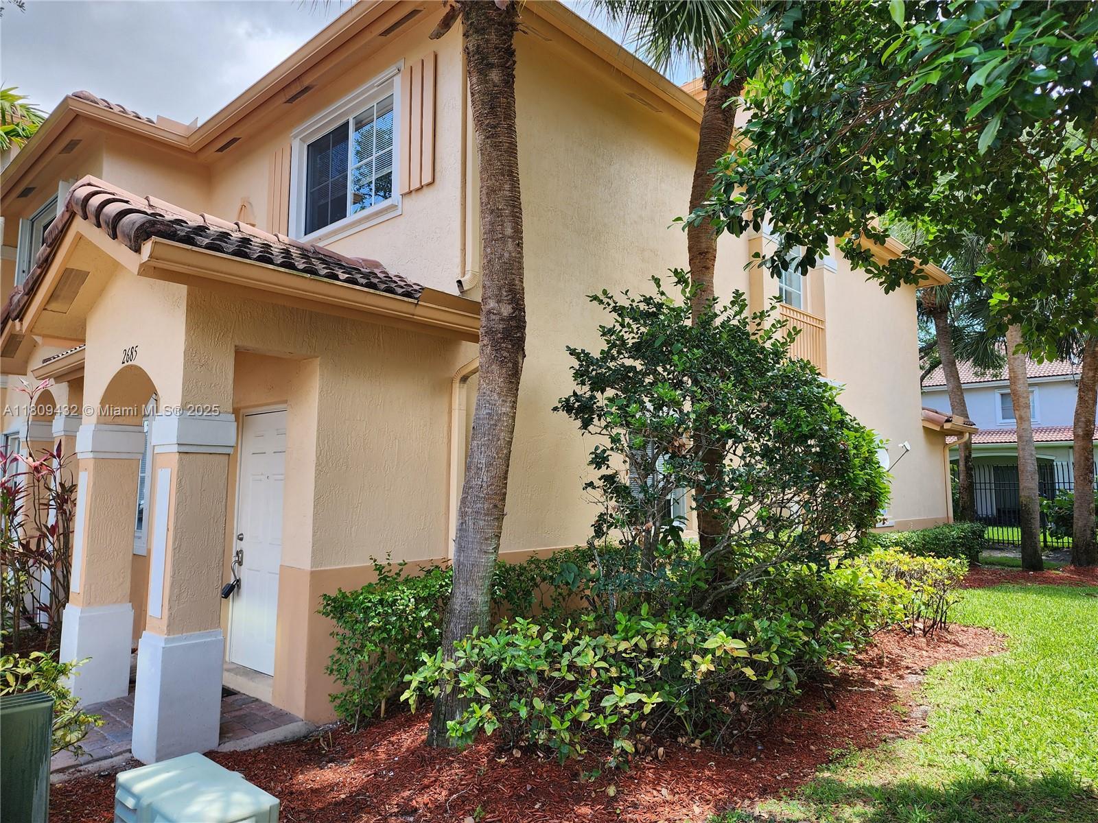 a front view of a house with garden