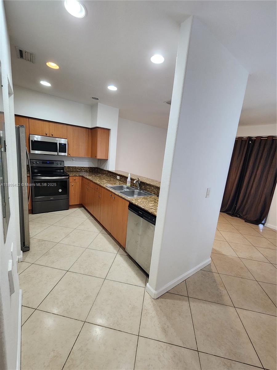 Miramar Miramar, FL 33025 - Photo 4 of 37 a kitchen with stainless steel appliances granite countertop a refrigerator and a sink