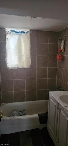 a bathroom with a shower toilet and sink