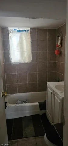 a bathroom with a sink a toilet a shower and a bathtub