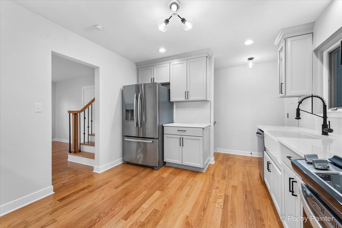 918 Delles Road Wheaton, IL 60189 - Photo 11 of 36 a kitchen with a refrigerator a sink and wooden floor
