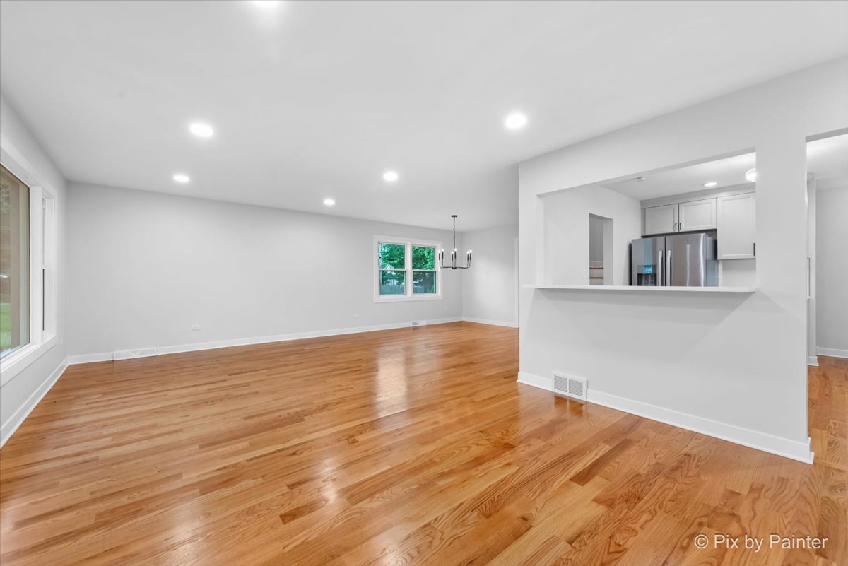 918 Delles Road Wheaton, IL 60189 - Photo 14 of 36 a view of empty room with wooden floor and kitchen