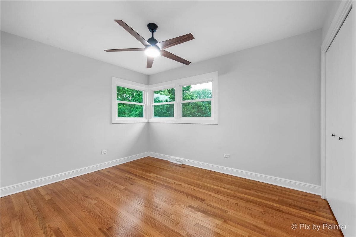 918 Delles Road Wheaton, IL 60189 - Photo 19 of 36 wooden floor in an empty room with a window