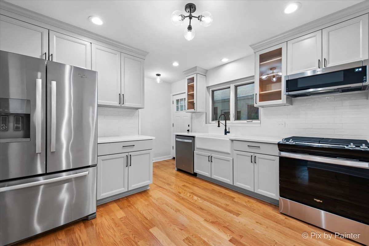 918 Delles Road Wheaton, IL 60189 - Photo 8 of 36 a kitchen with stainless steel appliances white cabinets a sink stove and refrigerator