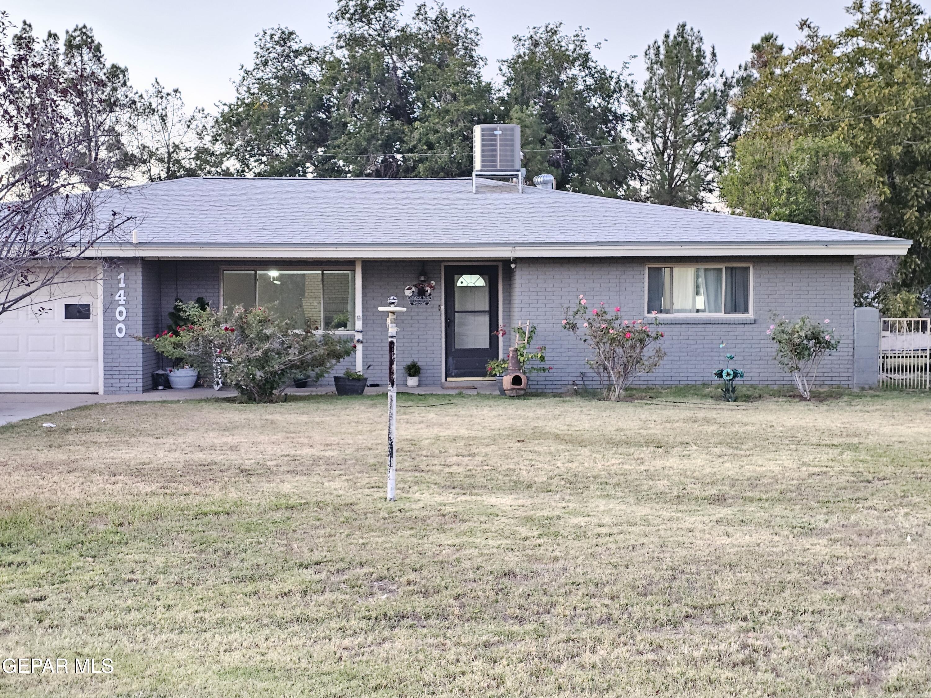 1400 San Andres Drive Las Cruces, NM 88007 - Photo 1 of 47 a front view of a house with garden