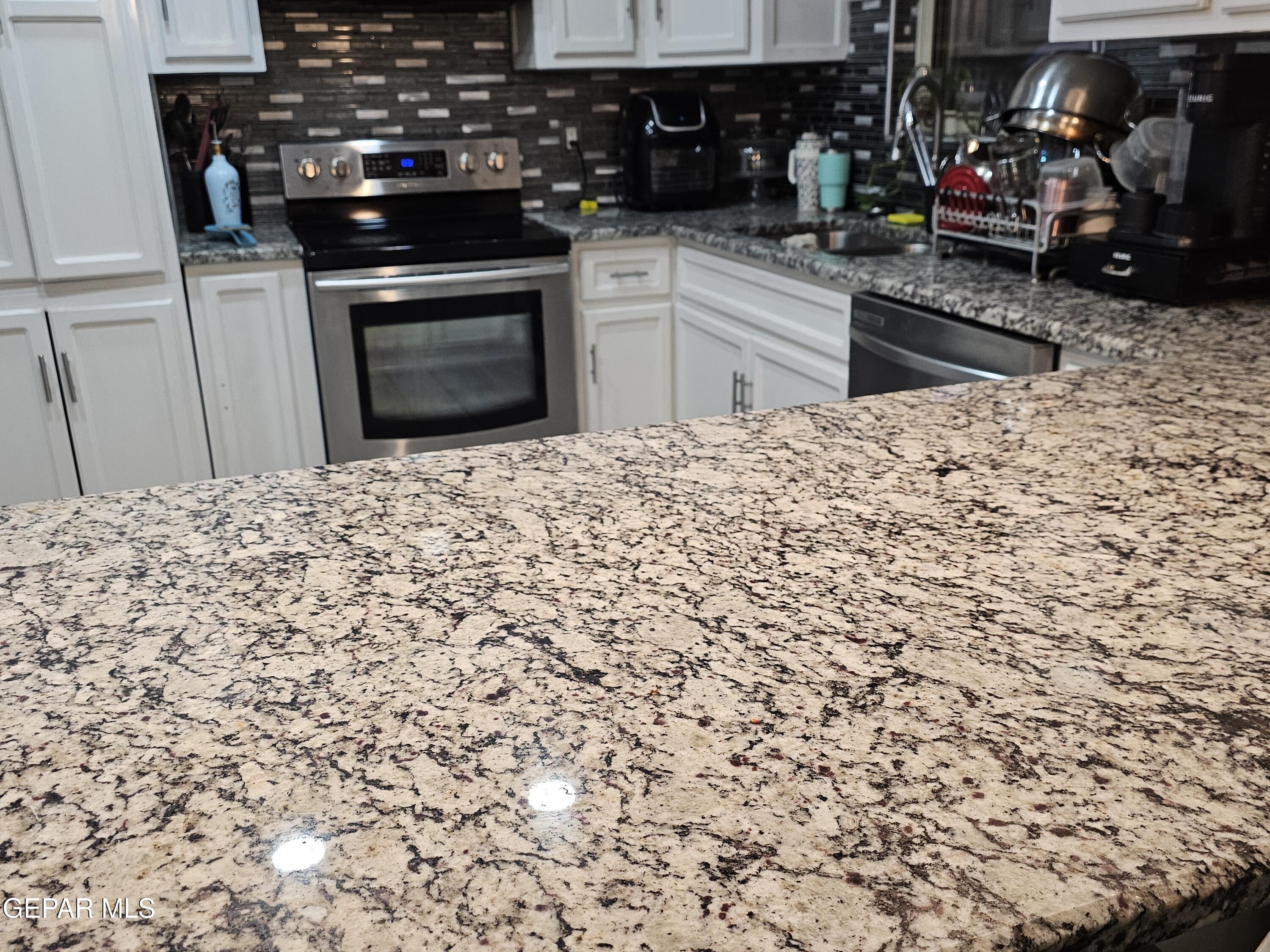1400 San Andres Drive Las Cruces, NM 88007 - Photo 15 of 47 a kitchen with a sink and cabinets